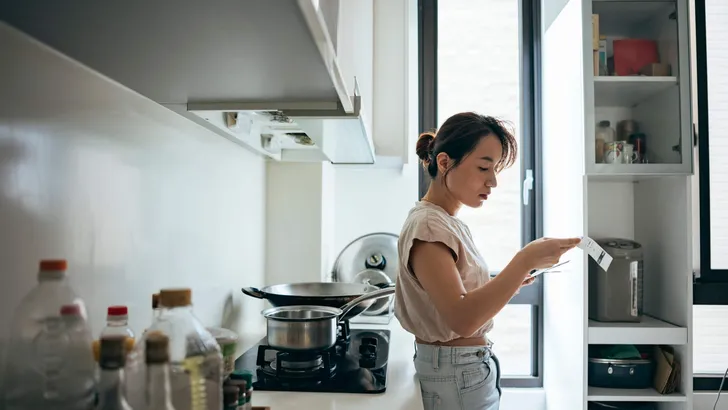 Asian women examining the shopping receipt at home