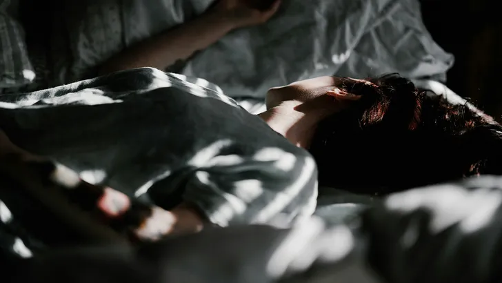 Vrouw die in bed ligt te slapen