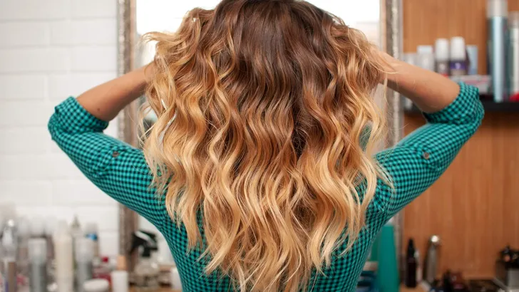 Beautiful ombre hair coloring on a girl with long hair, view from the back