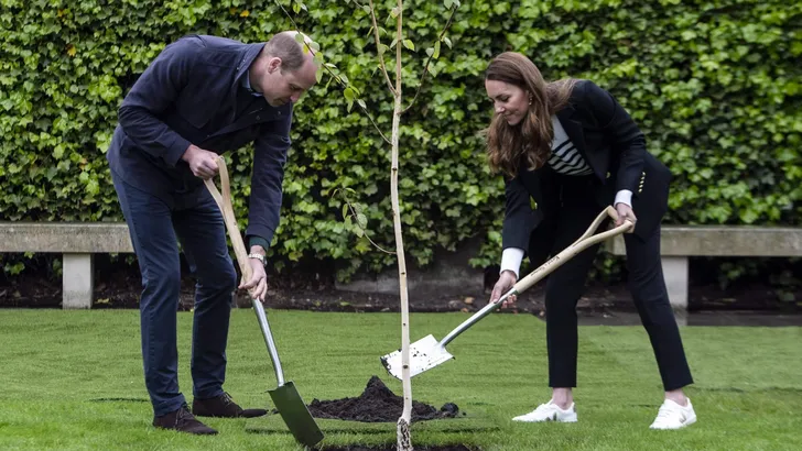 Britain's Catherine, Duchess of Cambridge and Britain's Prince William, Duke of Cambridge, take part in a tree planting ceremony as they visit the University of St Andrews in St Andrews on May 26, 2021.