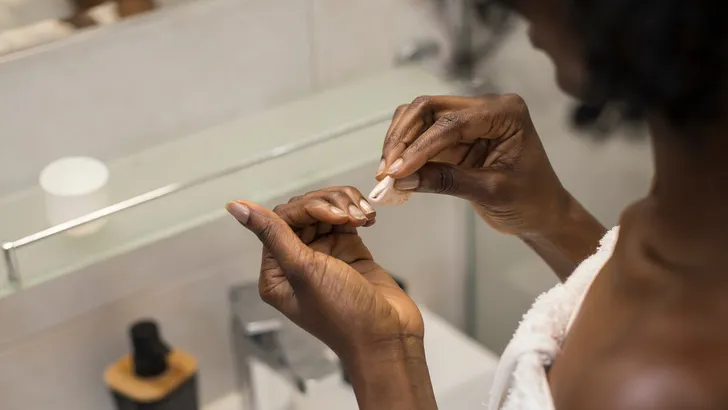 Woman removing her nail polish