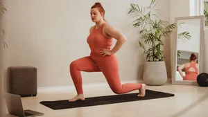 Woman exercising over online workout class