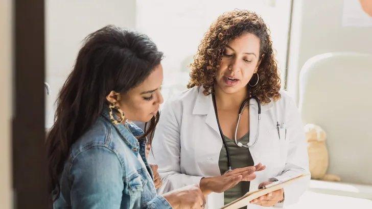 Pediatrician talks with patient's mother