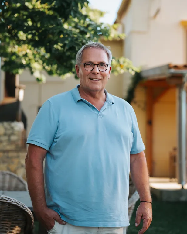 Paul poseert in een blauwe polo voor zijn B&B in Vidreres in Spanje voor B&B Vol Liefde 2026.