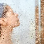 Woman take a shower at home.