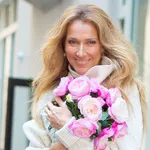 Celine Dion Leaves her Hotel in a Large Floral Dress Before Tossing a Bouquet of Flowers in The Street  in New York City