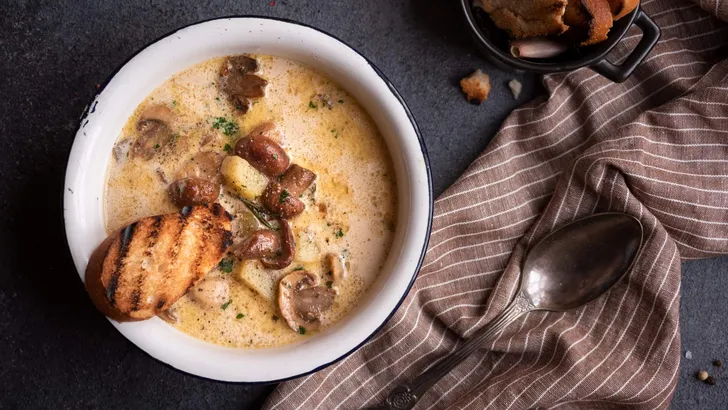 Porcini mushrooms creamy soup with grilled bread and parsley