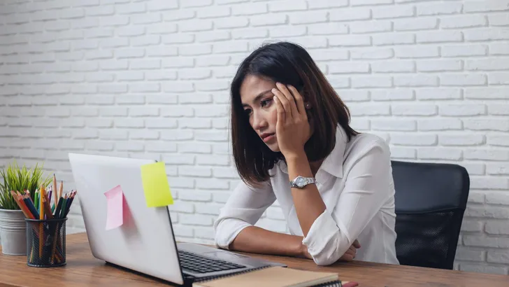 Desperate businesswoman worried in office
