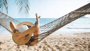 Traveler asian woman relax in hammock on summer beach Thailand