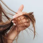 Girl holding her hair in her hand. Hair care concept. Shampoo. Haircut needed.