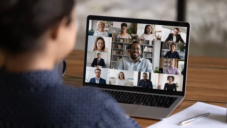 Rear view of woman talk on video call with colleagues