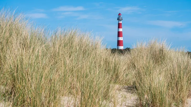 View on lighthouse in the dunes of Ameland, Holland