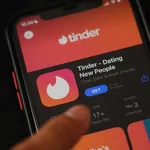 The Tinder application on the Iphone 11 Pro screen. Tinder is a location-based dating and social discovery service application.