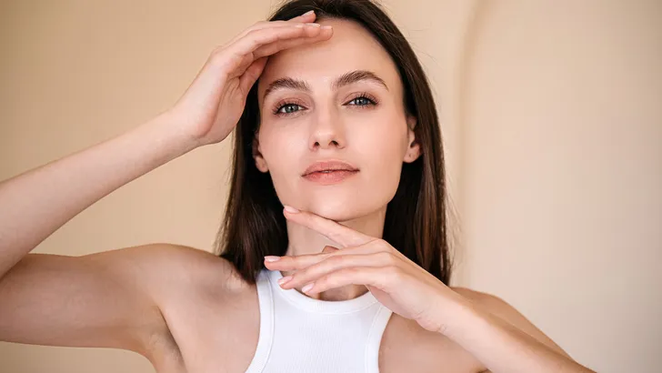 Portrait of young woman posing, looking at camera