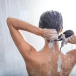 Woman using shampoo during taking shower