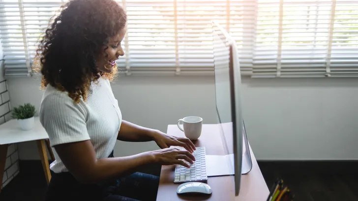 Smiling young African American Woman working on Computer.