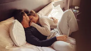 Loving couple sleeping together in bed