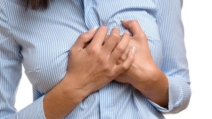 Woman clutching her breast in pain