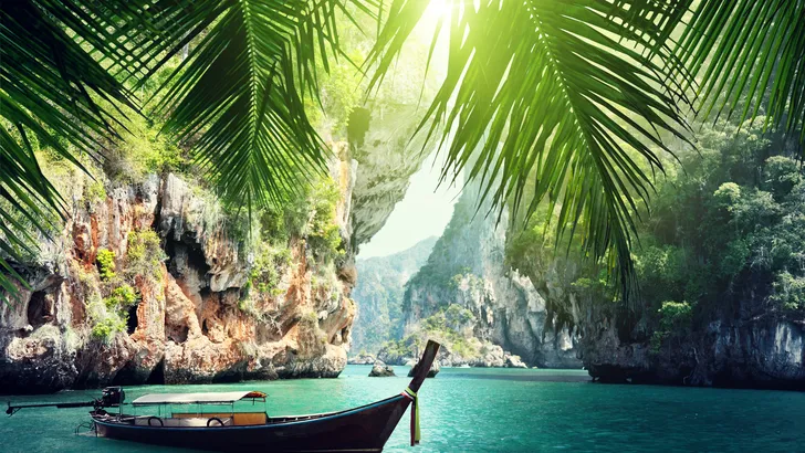 long boat and rocks on railay beach in Krabi, Thailand