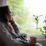 Depressed Woman Sitting by Window