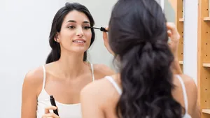 Woman applying mascara