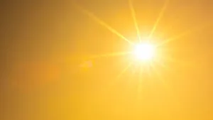 Hot summer or heat wave background, orange sky with glowing sun