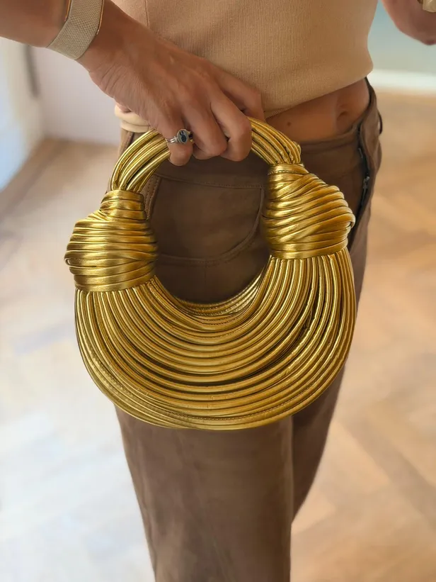 Gouden nep designertas van Bo Wilkes. 