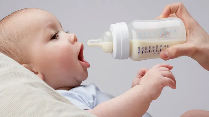 A baby being fed a bottle