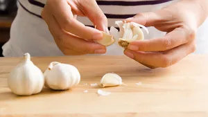 Woman peeling garlic by hand