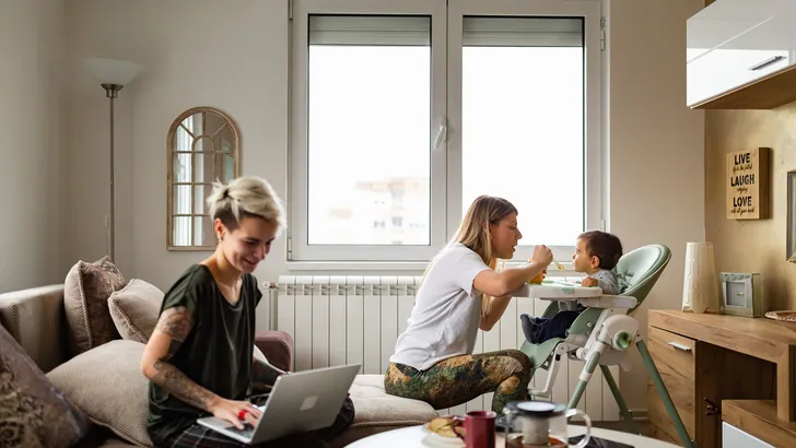 Family life. Lesbian couple with baby at home.