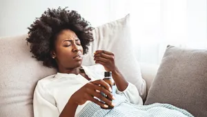 Girl drinks a medicine.