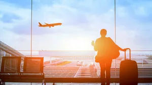 happy traveler waiting for the flight in airport