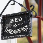 Cute metal Bed and Breakfast sign on building facade