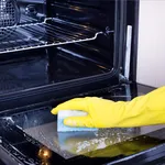 Woman cleaning oven