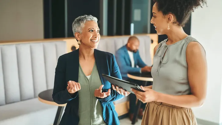 Communication, consulting and planning, business women meeting in the work lobby. A woman in leadership, ceo, team leader or coaching mentor, collaboration and motivation for office employee success