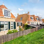 Back of old cottages alongside dike in historic town of Makkum, Friesland, Netherlands