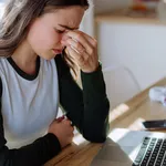 Portrait of tired woman with laptop, homeoffice concept.