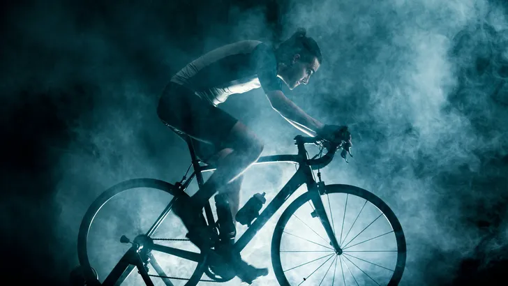 man die binnen aan het fietsen is op een trainer