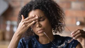 Frustrated black female freelancer overworked by computer feel headache migraine