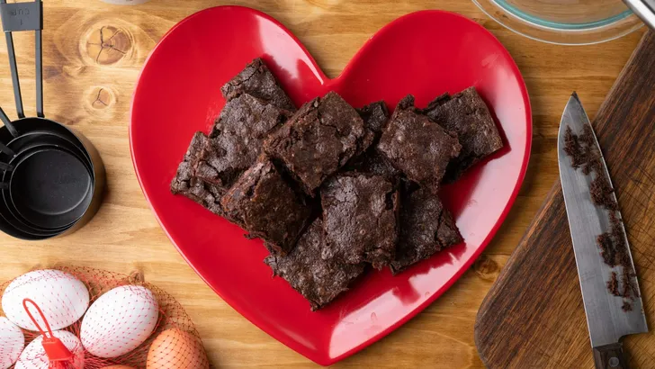 chocolate brownies on red heart shaped dish