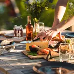 Man taking a slice of cheese at midsummer dinner