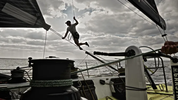 January 8, 2015. Leg 3 onboard Team Brunel. Gerd-Jan Poortman gets into the harness to make adjustm…