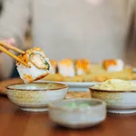 Woman eating sushi rolls