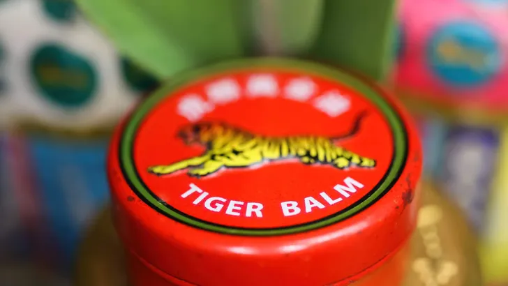 Viersen, Germany - May 9. 2022: Closeup of jar lid cover with asian analgetic heat tiger balm rub ointment