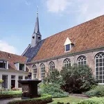 Old almshouses around a small, public courtyard