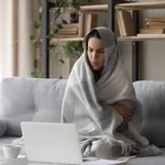 Sick woman feel cold at home covered with blanket