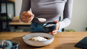 Close Up of Woman Hands Making Healthy Breakfast in Kitchen