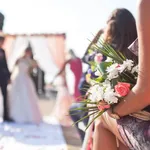 Wedding ceremony outdoors, focus on flowers bouquet