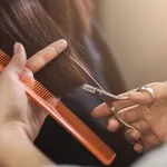 Cropped shot of female client receiving a haircut