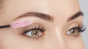 Beautiful Woman with long eyelashes in a beauty salon. Eyelash extension procedure. Cosmetology skin care